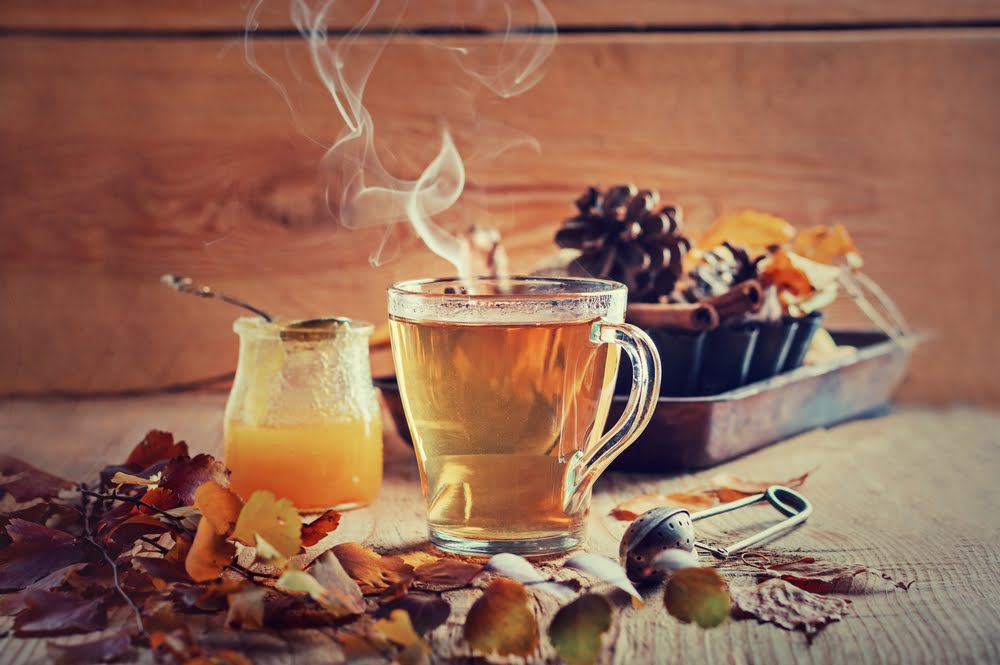 wooden counter top with tea and adaptogenic mushrooms and other seasonings