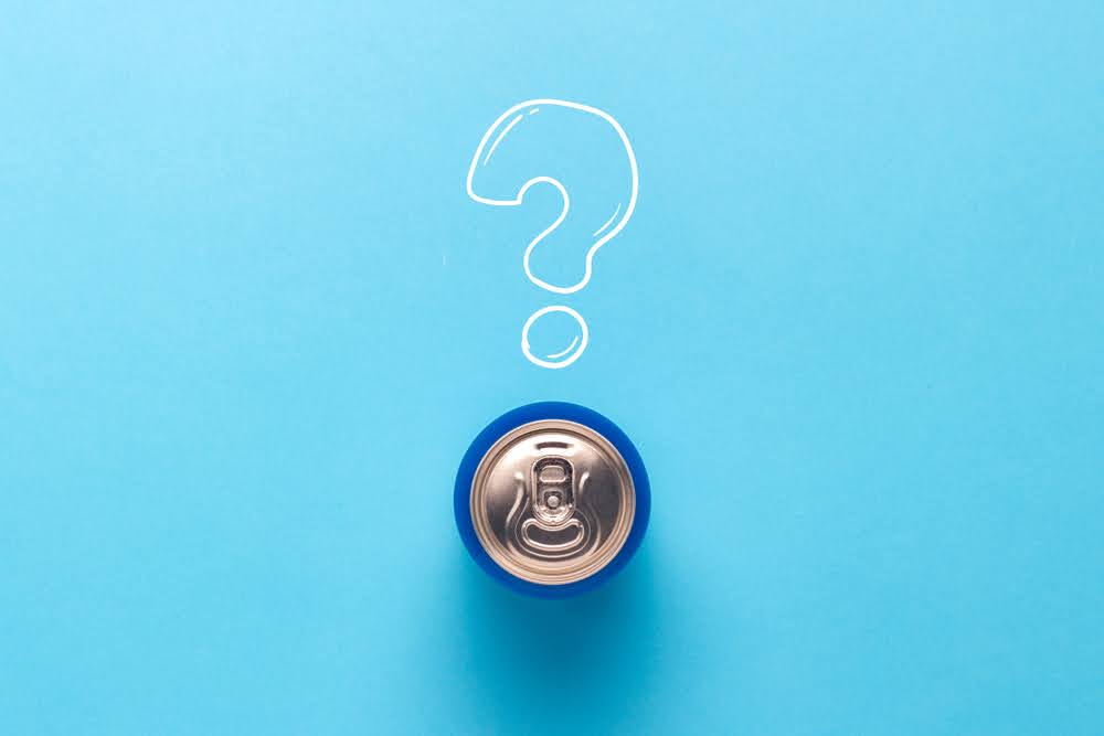 top of a beverage can on a blue counter with a question mark over top