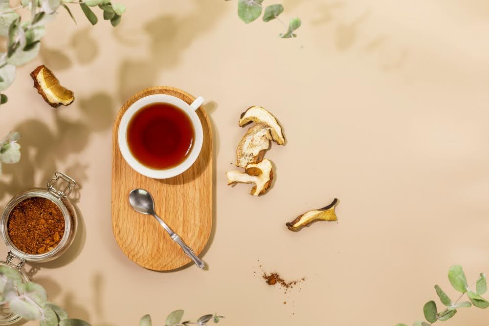 mushrooms and mushroom tea on a beige counter top