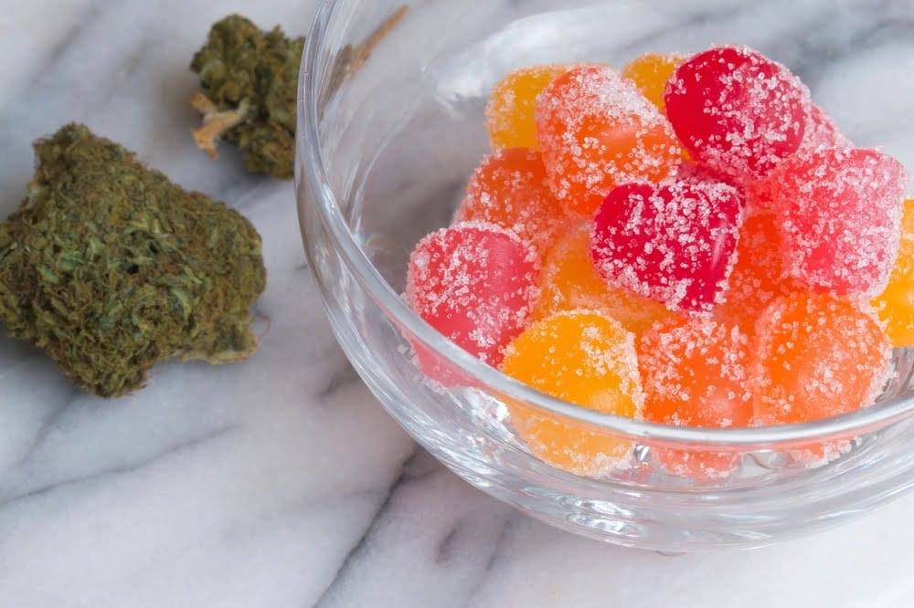 cbd gummies in a glass ramekin on a marble countertop
