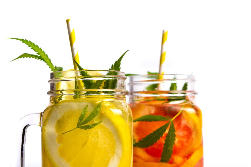 closeup two mason jars with THC infused drinks. One lemon and one blood orange