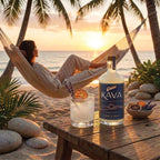 Woman relaxing in a beachside hammock at sunset next to a bottle of Oasis Kava Sunset Citrus and a poured citrus mocktail on a wooden table.
